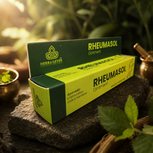 A box of Herbalever Rheumasol Ointment, featuring a dark green and bright yellow-green packaging, styled on a rustic stone with herbal props in a natural outdoor setting.